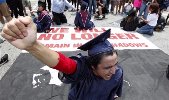 A protester blocks a street during a rally protesting Georgia's new immigration law on the Capitol steps Monday, June 28, 2011 in Atlanta. Six young illegal immigrants were arrested after they sat down in an intersection next to the Georgia Capitol blocking traffic to protest state policies targeting illegal immigration. (AP Photo/John Bazemore)
